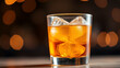 © Julian - A close-up of a glass containing amber beverage with ice, set against a blurred bokeh background.