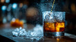 © Shahazadi - A glass of whiskey with ice being poured in a dark bar