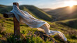 © Kateryna - Close up of a rough wooden cross wrapped in white linen cloth blowing gently in a morning breeze on a green hilltop the fabric billowing and catching sunlight the cross emerging