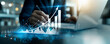 © Benjamin - Businessman using laptop analyzing sales data and economic growth graph chart, Business strategy and planning, marketing report, business development concept.