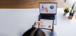 © groviapoto - A bird's-eye view of a professional examining sales performance data on a tablet, while also considering a laptop report, highlighting the importance of analytics in business.