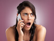 © peopleimages.com - Gossip, phone call and shock with woman on studio background for expression, news or reaction. OMG, surprise and wow emoji with speechless person talking on mobile for disbelief in rumor or scandal