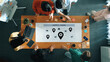 © InfiniteFlow - A diverse team collaborates around a supply chain strategy on a wooden table, utilizing laptops and colorful notes to enhance productivity and communication in a modern workspace. Ledger