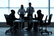 © Pixel-Shot - Silhouettes of business people working at table in office