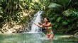 © Fiverr/fazilazia703 - Joyful young African American woman in a colorful bikini, playing and splashing water in a natural pool by a tropical waterfall, surrounded by lush green rainforest.