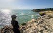 © Angelov - Woman Gazing at the Ocean from a Cliff