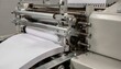 © Justlight - Closeup medium shot highlighting matte magazine saddle stitching machine folding and stapling multipage issues machinery details clear against softly blurred surroundings.