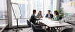 © fizkes - Diverse corporate team holding open discussion by conference table collaborating on shared project exchanging ideas insights on strategic development interacting on staff briefing in modern boardroom