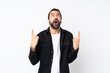 © luismolinero - Young man with beard over isolated white background surprised and pointing up