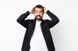 © luismolinero - Young man with beard over isolated white background frustrated and takes hands on head