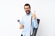 © luismolinero - Young architect man with beard over isolated white background making rock gesture