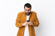 © luismolinero - Caucasian handsome man with beard wearing a corduroy jacket over isolated white background surprised and sending a message