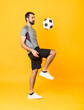 © luismolinero - Full-length shot of a football player man over isolated yellow background
