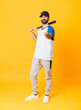 © luismolinero - Full-length shot of man over isolated yellow background playing baseball