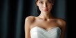 © NovaVision - Elegant bride in a white strapless wedding dress with diamond earrings, soft lighting