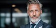 © NovaVision - Mature businessman with distinguished grey beard and stylish hair, exuding confidence