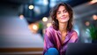 © NovaVision - Smiling woman with blue eyes wearing a purple blouse, looking at the camera in a modern office setting