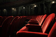 © yalli - Close-up of rows of plush, red velvet seating in a dimly lit, classical auditorium, hinting at an imminent performance