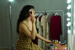 © AntonioDiaz - Model applying makeup at a vanity table backstage, preparing for a fashion show or important event