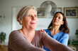 © Halfpoint - Physiotherapist helping senior woman during rehabilitation exercise at home.