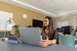 © wavebreak3 - Diverse coworkers, Indian woman in embroidered tunic collaborating at office with laptop and tablet