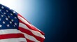 © FATHER'S STUDIO - A close up view of the american flag waving against a dark blue background for national holidays