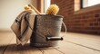 © Rezzr - Rustic galvanized metal Cleaning Bucket filled with cleaning supplies, including a dishcloth and brushes, on a wooden floor
