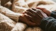 © Anat art - Hands Connect Gently on a Soft Wool Blanket in a Quiet Living Room, Showcasing Care and Warmth Between a Younger and an Older Person