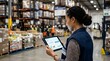 © A5 - Professional female logistics manager holding a digital tablet with data analytics and charts while standing in a large warehouse with industrial shelving and pallet storage.