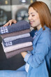 © auremar - woman holding a pile of ironed clean towels
