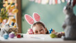 © Konstantin Yuganov - Joyful Child Wearing Bunny Ears Celebrating Easter with Colorful Eggs Indoors