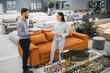 © Serhii - Female client consulting male sales consultant in furniture shop