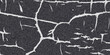 © Brainless - Cracked asphalt texture with white fissures and a dark granular surface creating a distressed and weathered abstract background for grunge and urban design themes