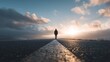 © Shah Zain - A person walks alone on a road towards the sunset with cloudy skies and wet ground.