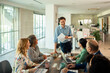 © Marko Geber - Business team meeting with leader presenting in modern office
