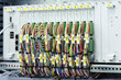 © Aleksandr Matveev - Industrial control panel with many colored cables. Cables are neatly bundled and labeled for easy identification. Each cable connects to specific port on panel