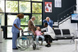 © DC Studio - Elderly grandparents worried and shocked after child collapses at hospital, calling for immediate attention and first aid from medical team during pediatric health scare in waiting area.