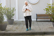 © artmim - Young man walking and talking on phone outdoors