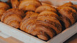 © Наталья Добровольска - Freshly baked croissants arranged in a wooden tray on display
