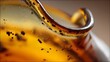© Prasojo - Close-up macro reveals a curved, translucent amber-colored material with small, dark inclusions, possibly trapped insects. The curve is glossy