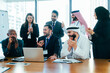 © oneinchpunch - Diverse corporate team applauding success during business meeting in dubai office