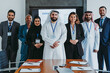 © oneinchpunch - Multiethnic business team posing in corporate office meeting