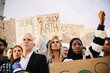 © Xavier Lorenzo - Diverse activists collaborating during environmental demonstration, expressing concern for global warming, displaying powerful messages on cardboard signs to advocate for ecological conservation