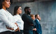 © alphaspirit - Group of people standing together with arms crossed in a modern setting during a formal event at a workplace