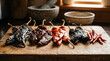 © mr_marcom - Dried chili pepper varieties including ancho guajillo and chipotle on wood