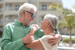 © luciano - Portrait of a beautiful elderly couple embracing in the sunshine, gazing affectionately into each other's eyes enjoying a peaceful moment together