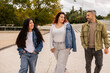 © ADDICTIVE STOCK - Multiethnic friends walking together in city environment