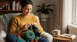 © NN AI - Woman knitting with colorful yarn while sitting in armchair at home. Relaxing hobby with hot tea and book by window. Cozy lifestyle and craft concept