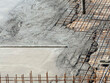 © ADDICTIVE STOCK - Concrete pouring over steel mesh in construction site