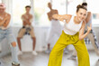 © JackF - Teenage girl rehearsing hip hop dance in group in dance studio